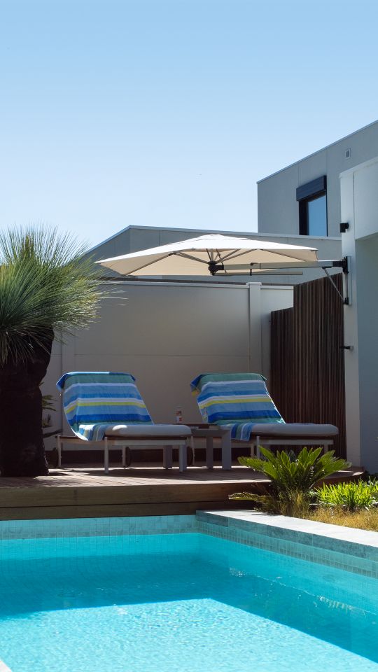 wall mounted umbrella over the pool